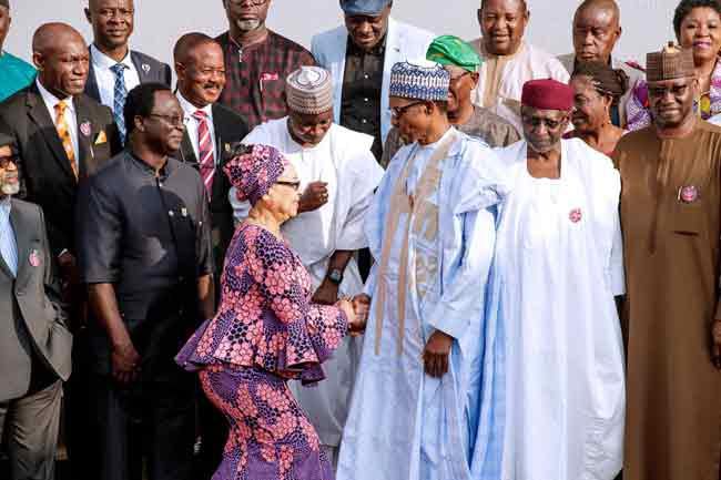Chairman of the Tripartite Committee, Amal Pepple(L) shaking President Buhari (R)