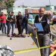 Egyptian investigators gather around the body of a suicide bomber who blew himself up near a Coptic Orthodox church on the edge of Cairo on August 11, 2018