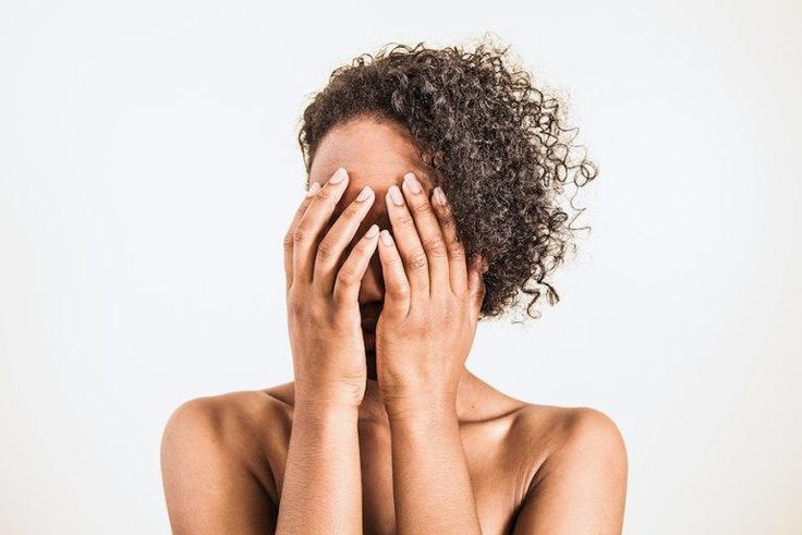 Embarrassed woman covers face in shame