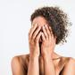 Embarrassed woman covers face in shame