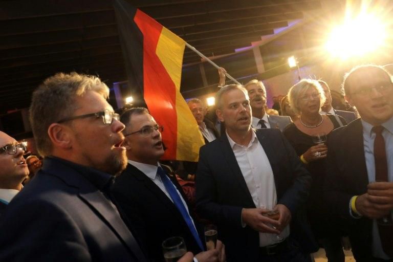 Supporters of the anti-immigrant Alternative for Germany party (AfD) celebrate as exit polls show their party making major gains in the Hesse state regional election