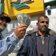 A Palestinian man shows his money after receiving his salary in Rafah in the southern Gaza Strip November 9, 2018