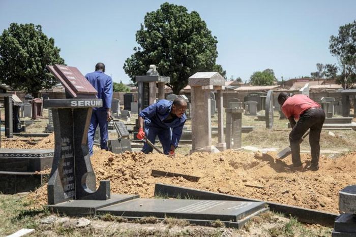 Gravediggers in Johannesburg, where between 45 and 60 graves are re-opened each week on average to allow for second burials