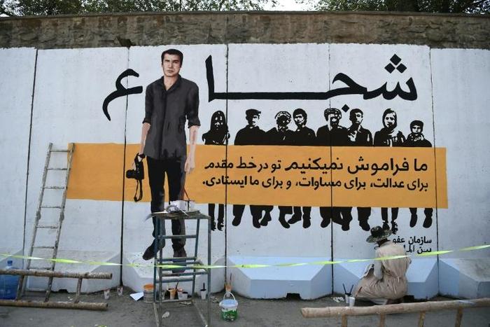 AFP's chief photographer in Afghanistan, Shah Marai, depicted on a mural in Kabul, was among 25 people killed along with eight other journalists, in an April bomb attack