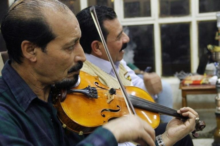 An Iraqi musician performs at a book fair in Mosul on November 6, 2018