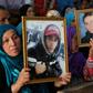 Families of victims of Tunisia's 2011 revolt against dictatorship carry portraits of their loved ones during a trial in Kasserine on July 13, 2018