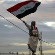 An Iraqi man waves his national flag in Baghdad's Tahrir Square on December 10, 2017, during a gathering celebrating the end of the three-year war against the Islamic State (IS) group