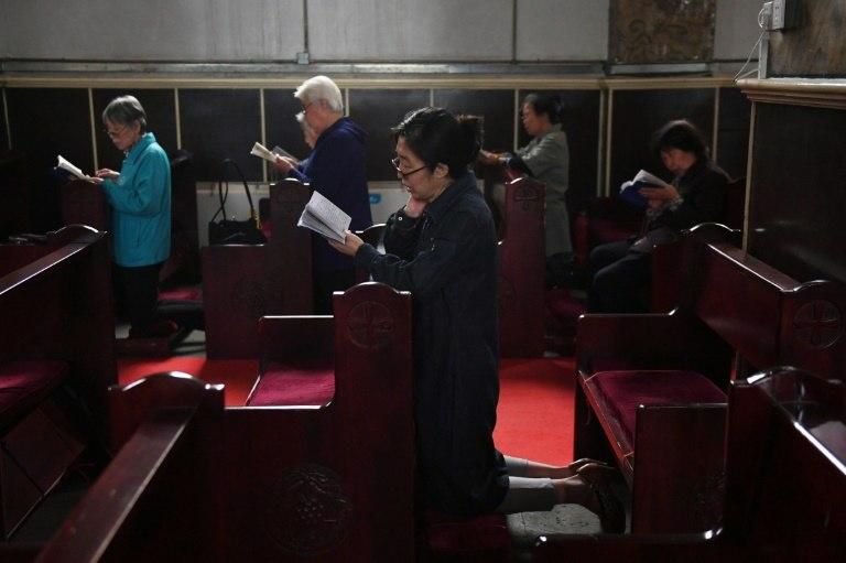 Catholic worshippers attend a mass at the government-sanctioned South Cathedral in Beijing