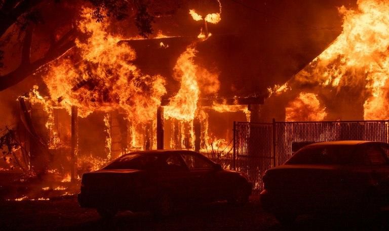 A home burns as a wildfire tears through the town of Paradise in northern California