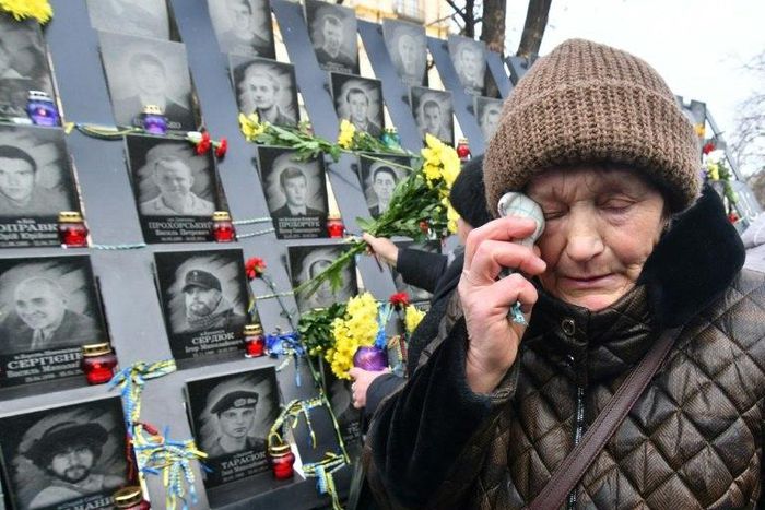 A woman cries at a memorial for the "Heavenly Hundred" who died during protests in Kiev's Maidan Square five years ago