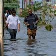 People wading through a flooded street in Havana, on December 21, 2018: Cuba blamed last year's Hurricane Irma as well as US sanctions for the fact that it won't be able to pay off its debt commitments in 2019