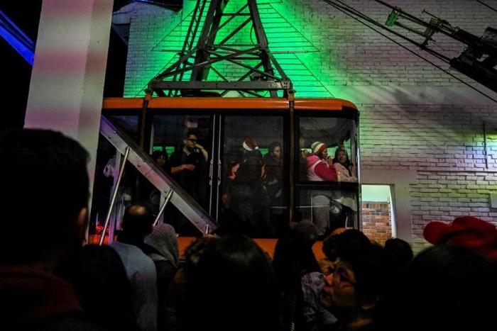 Colombian passengers ride Bogota's first cable car alongside the Monserrate mountain