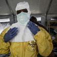 A medical worker puts on his Personal Protective Equipment (PPE) ahead of entering an Ebola Treatment Centre in Beni