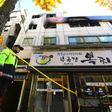 A South Korean policeman stands guard outside the scene after a fire that killed at least seven people in Seoul