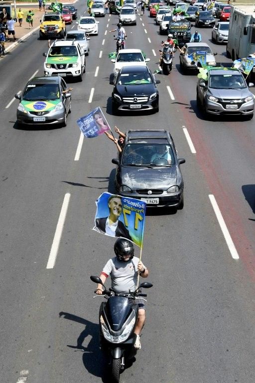 Supporters of Brazil?s far-right presidential candidate Jair Bolsonaro take part in a campaign rally in Brasilia, on the eve of the ballot which he is favored to win