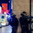 Police officers stand guard near the scene of a shooting in the French city of Strasbourg that has prompted President Donald Trump to renew calls for a wall along the US-Mexico border