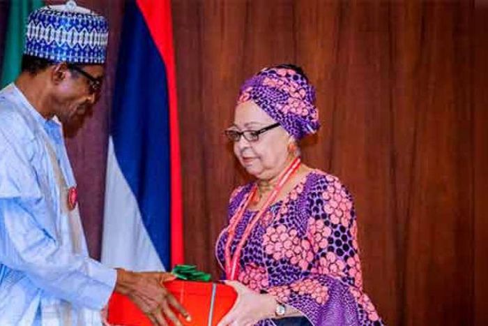 President Muhammdu Buhari receiving the report of the Tripartite Committee on the Review of National Minimum Wage from the Committee Chairman, Mrs Amal Pepple, at the State House on November 6, 2018.