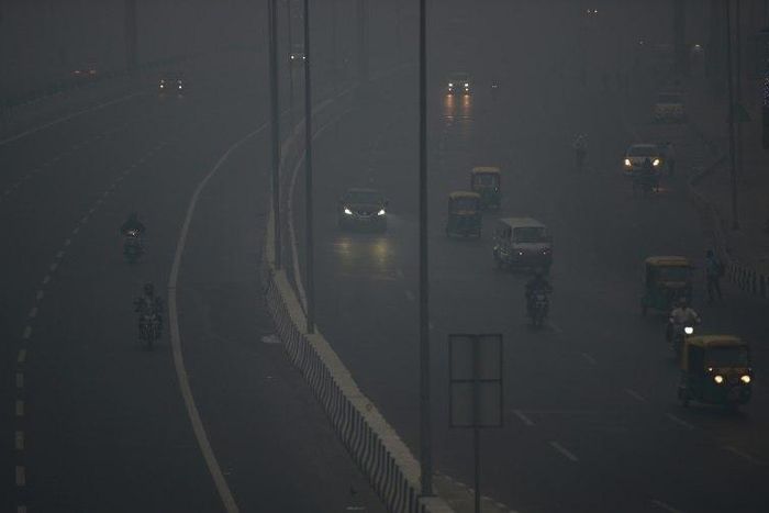 Commuters travel amid heavy smog in New Delhi after a night of free-for-all Diwali fireworks
