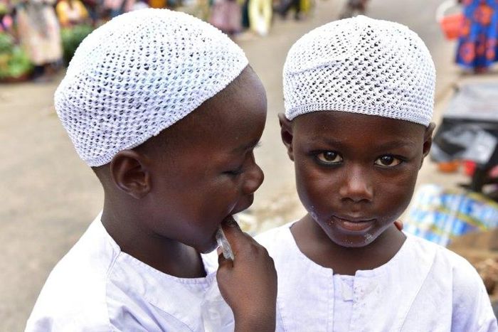 Twin brothers Salim and Mahamadou Cisse, just five years old, beg at the busy market of Abobo, a suburb of Ivory Coast's commercial capital Abidjan