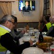 'Yellow vest' protestors take notes as they watch French President Emmanuel Macron's speech on television