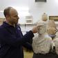 Israeli archaeologist Eitan Klein of the Israel Antiquities Authority shows off two late Roman busts unearthed near the ancient city of Beit Shean following a chance find by a woman walker