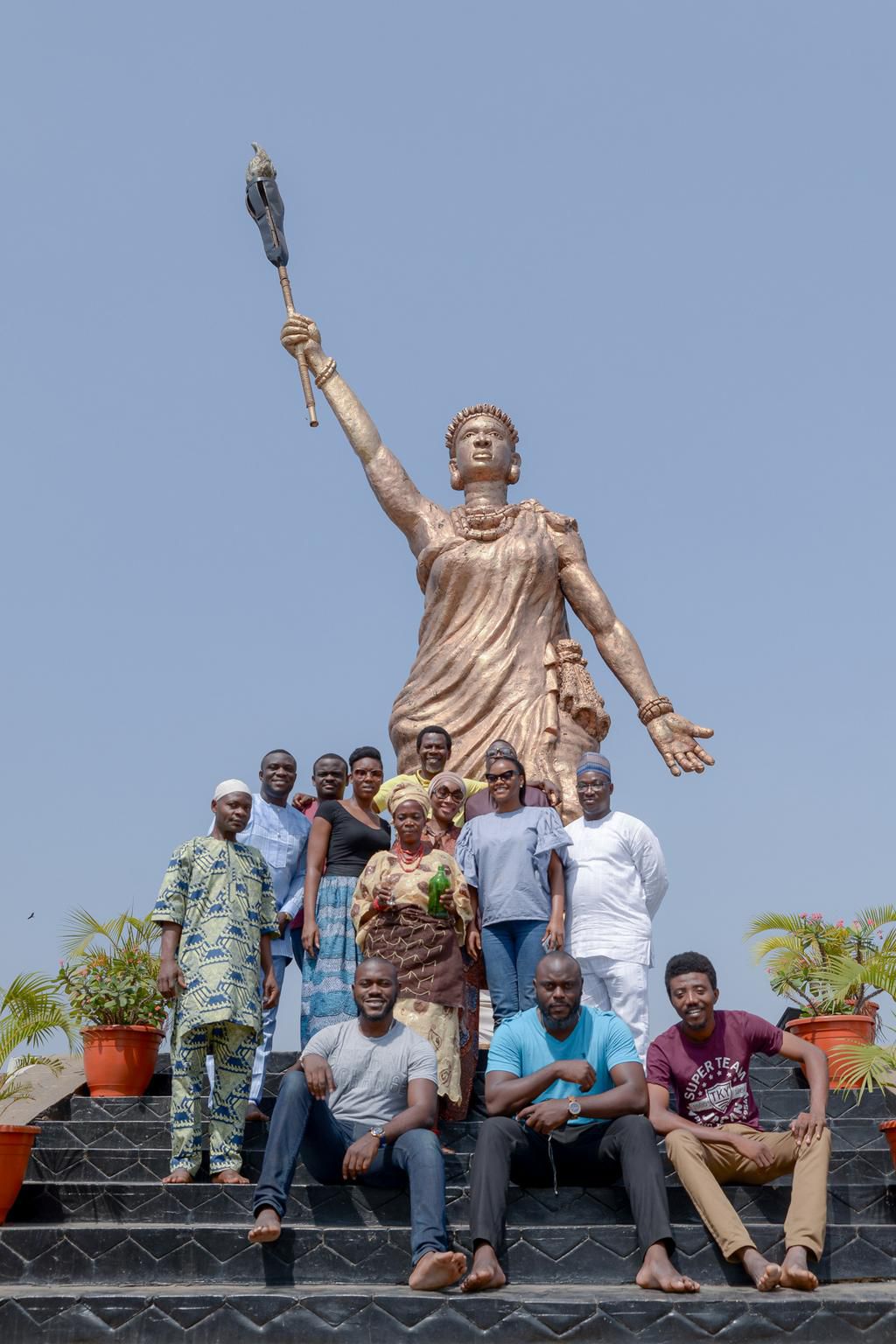 The cast and crew of Queen Moremi: The Musical at the Moremi statue in Ile Ife