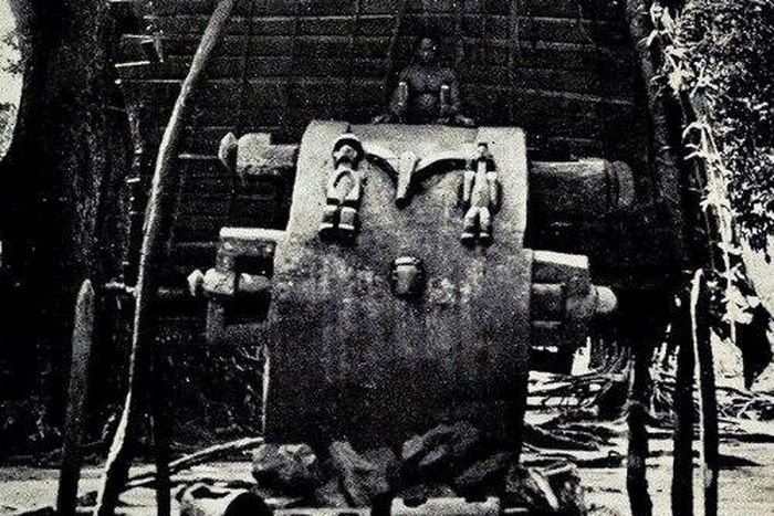 Giant ikoro wooden slit drum of Umunze being beaten by a males with sticks