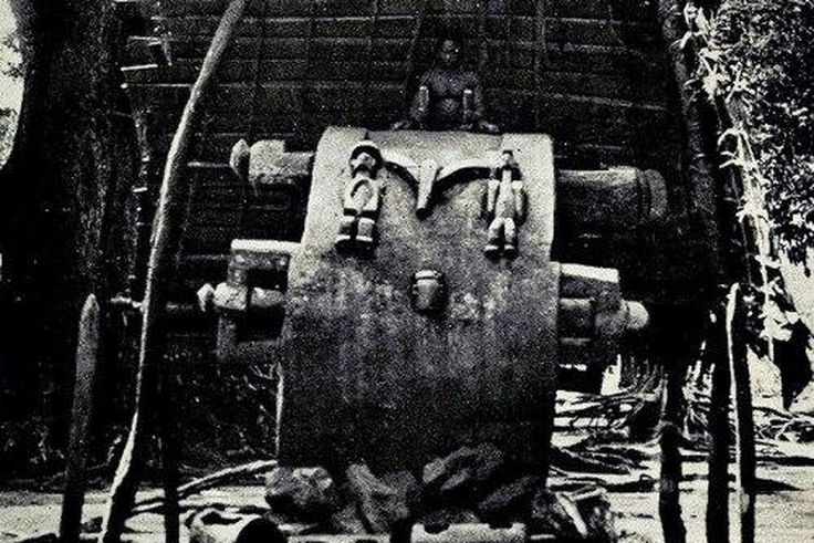 Giant ikoro wooden slit drum of Umunze being beaten by a males with sticks