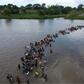 Central American migrants are seen here crossing the Suchiate River into Mexico in November on their way to the United States