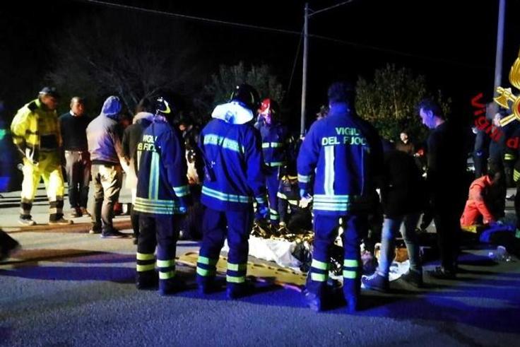 A handout picture taken and released by the Italian fire and rescue service shows emergency services staff treating victims of the stampede at a nightclub in Cornaldo