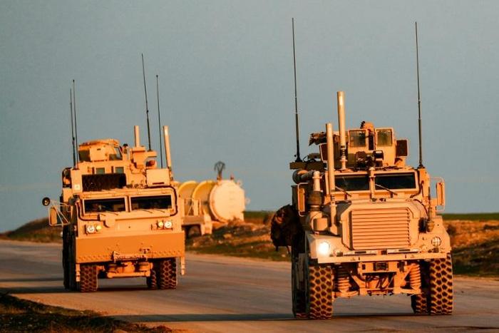 US Marine Corps tactical vehicles are seen near the Syrian town of Tal Baydar in northeastern Hasakeh province on December 21, 2018