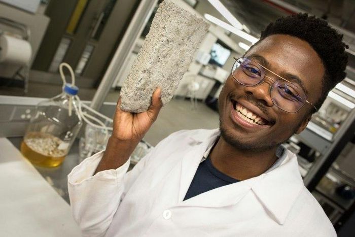 Mind over bladder: Vukheta Mukhari, one of the developers of the world's first bio-brick based on human urine, shows off a prototype