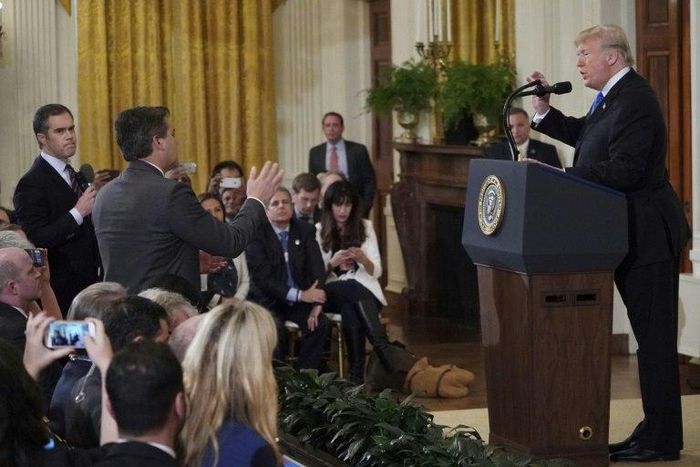 US President Donald Trump spars with CNN journalist Jim Acosta (C) and NBC's Peter Alexander (L), who came to Acosta's defense