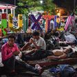 Thousands of migrants in a caravan marching towards the US rest in the Mexican town of Huixtla -- most have been walking for days, and are nursing various injuries