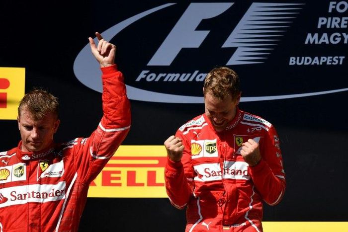Ferrari's Sebastian Vettel (right) and Kimi Raikkonen celebrate on the podium after the Hungarian Grand Prix in Budapest on July 30, 2017