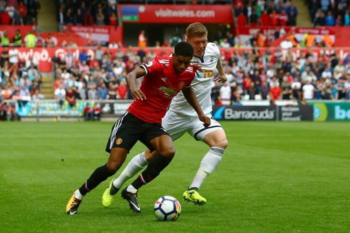 Manchester United's Marcus Rashford (L) vies with Swansea City's Alfie Mawson during their match in Swansea, south Wales on August 19