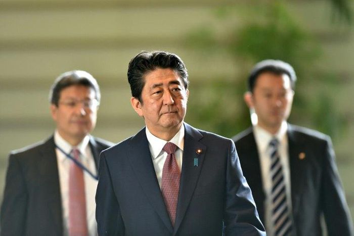 Japanese Prime Minister Shinzo Abe (C) has seen public support rates plummet in the past few months over an array of political troubles