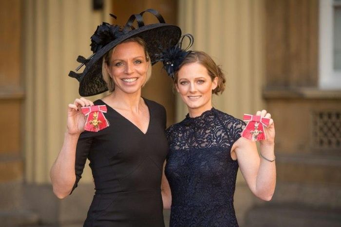 Former Great Britain hockey captain Kate Richardson-Walsh (L) and her wife Helen pose at Buckingham Palace in London after the investiture ceremony where they received an OBE and MBE respectively on February 17, 2017
