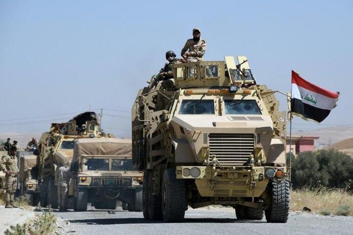 Iraqi government forces drive down a road leading to Tal Afar on June 9, 2017, before the official start of the assault to retake the town from the Islamic State group