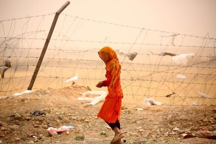 Monitors says more civilians are dying in US air strikes under President Donald Trump, particularly near the IS stronghold of Raqa. The Pentagon disputes that. A woman who was among Syrians who fled Raqa is seen here at a temporary camp