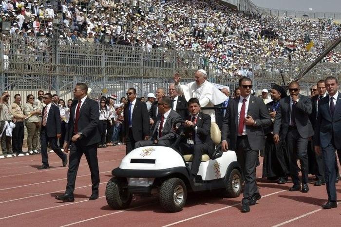 Pope Francis is surrounded by security before the start of a mass on April 29, 2017 at a stadium in Cairo