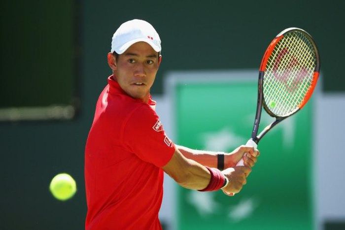 Kei Nishikori of Japan plays a backhand against Gilles Muller of Luxembourg in their third round match during day nine of the BNP Paribas Open at Indian Wells Tennis Garden on March 14, 2017
