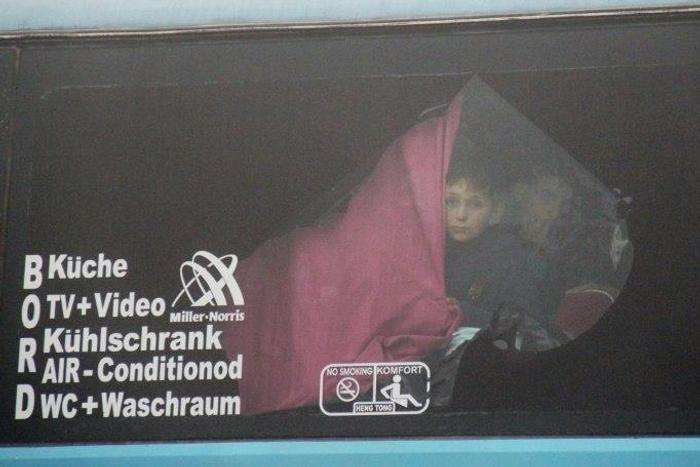 A Syrian boy onboard a bus from government-held Fuaa and Kafraya arrives in rebel-held Rashidin as part of an evacuation deal on April 14, 2017
