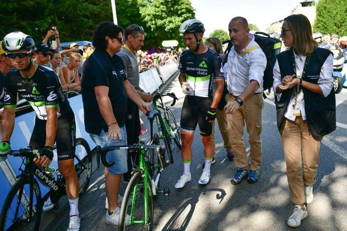 Great Britain's Mark Cavendish (C), injured, speaks after falling near the finish line at the end of the 207,5 km fourth stage of the 104th edition of the Tour de France cycling race on July 4, 2017 between Mondorf-les-Bains and Vittel