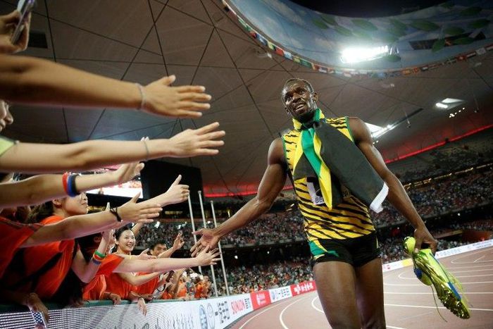 Jamaica's Usain Bolt celebrates with fans after winning the final of the 200m event at the 2015 IAAF World Championships in Beijing