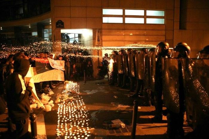 Protestors shoot fireworks at the riot squad in Paris two days after a Chinese man is killed by police, march 29, 2017