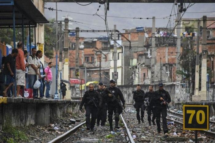 Rio police, shown here carrying out a pre-dawn crackdown on drug gangs in a favela, are demoralized and struggling to contain violence