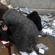 A woman helps a victim of the terror attack which a car plough down pedestrians on London Bridge on Saturday, June 3, 2017.
