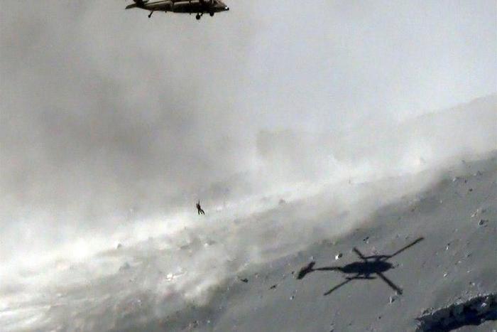 A helicopter from Japan's Self Defence Force lifts a survivor during a 2014 mountain rescue in Nagano prefecture, central Japan