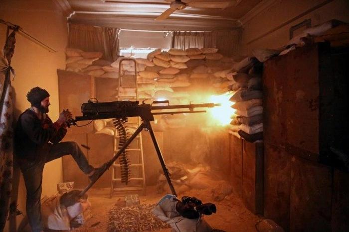 A Syrian opposition fighter fires a heavy machine gun in Jobar, a rebel-held district on the eastern outskirts of the Syrian capital Damascus, on March 19, 2017